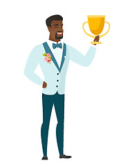 Image showing African-american groom holding a trophy.