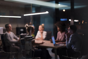 Image showing Multiethnic startup business team in night office