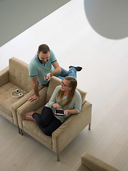 Image showing couple relaxing at  home with tablet computers