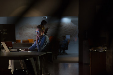 Image showing man working on computer in dark office