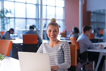 Image showing businesswoman using a laptop in startup office