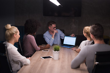 Image showing Multiethnic startup business team in night office