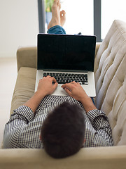 Image showing Man using laptop in living room