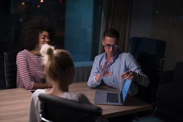 Image showing Multiethnic startup business team in night office