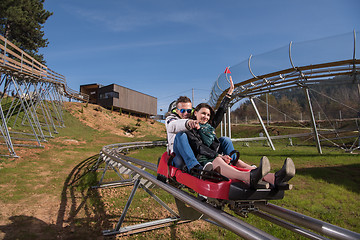 Image showing couple enjoys driving on alpine coaster