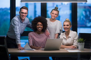 Image showing Multiethnic startup business team in night office