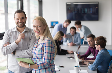 Image showing Two Business People Working With Tablet in office