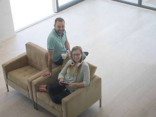 Image showing couple relaxing at  home with tablet computers