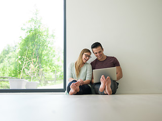 Image showing couple using laptop on the floor at home