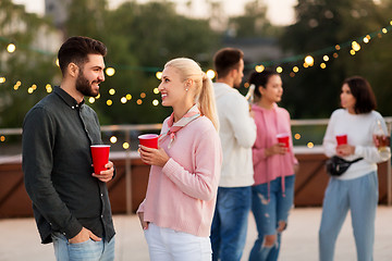 Image showing friends with drinks in party cups at rooftop