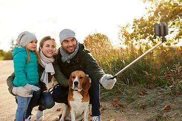 Image showing happy family with dog taking selfie in autumn