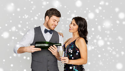 Image showing happy couple with champagne celebrating christmas