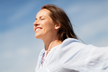 Image showing happy smiling woman enjoying sun