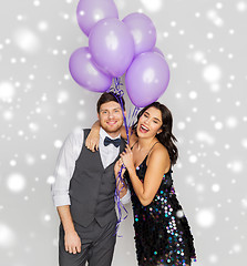 Image showing happy couple with ultra violet balloons at party