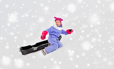 Image showing little girl with sled on snow hill in winter