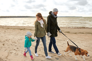 Image showing happy family walking with beagle dog in autumn