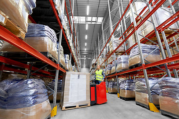 Image showing loader operating forklift at warehouse