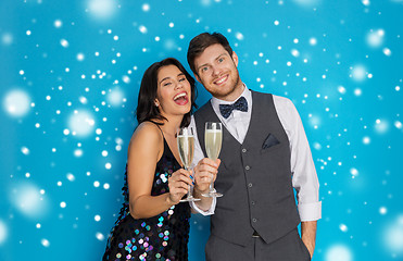 Image showing happy couple with champagne celebrating christmas