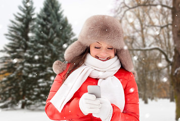 Image showing happy woman with smartphone in winter