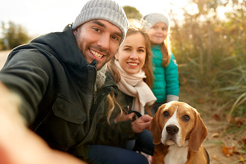 Image showing happy family with dog taking selfie in autumn