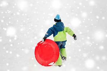 Image showing happy boy with snow saucer sled in winter