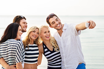 Image showing happy friends taking selfie on summer beach