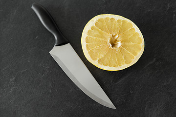 Image showing close up of chopped lemon and knife on table