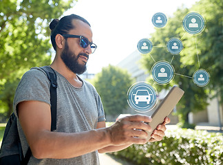 Image showing man using car sharing app on tablet pc in city