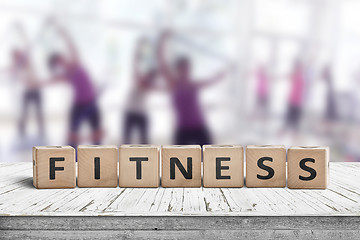 Image showing Fitness sign on a table in a gym with women