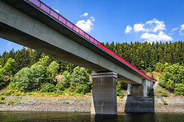 Image showing Bridge with red fence over a lake in the summer