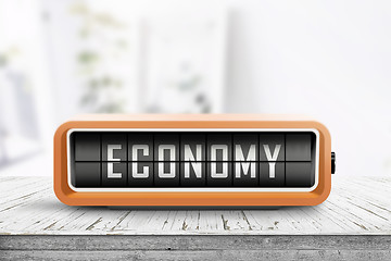 Image showing Economy word on an analog device in a bright home