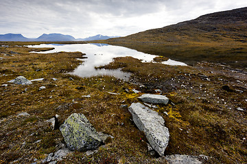 Image showing Lake and stones in autumn mountains. Northern Sweden