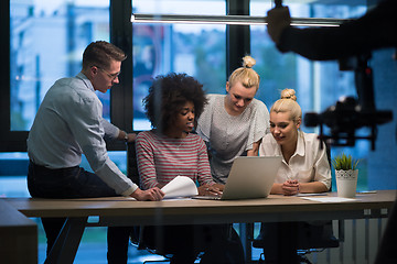 Image showing Multiethnic startup business team in night office