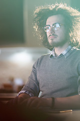 Image showing man working on computer in dark office