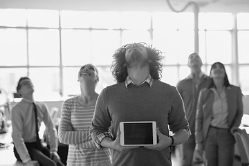 Image showing Portrait of a young businessman holding tablet