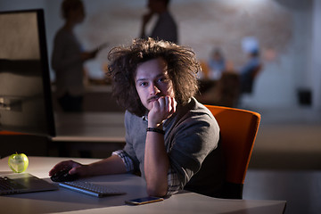 Image showing man working on computer in dark office