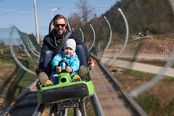 Image showing father and son enjoys driving on alpine coaster