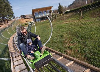 Image showing father and son enjoys driving on alpine coaster