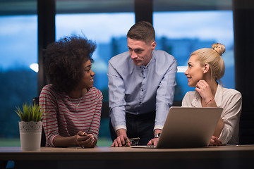 Image showing Multiethnic startup business team in night office