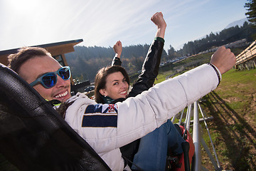 Image showing couple enjoys driving on alpine coaster