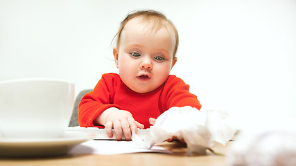 Image showing Happy child baby girl toddler sitting with keyboard of computer isolated on a white background