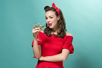 Image showing Beautiful young woman with pinup make-up and hairstyle. Studio shot on white background