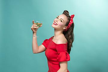 Image showing Beautiful young woman with pinup make-up and hairstyle. Studio shot on white background