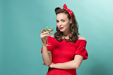 Image showing Beautiful young woman with pinup make-up and hairstyle. Studio shot on white background