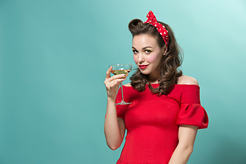 Image showing Beautiful young woman with pinup make-up and hairstyle. Studio shot on white background