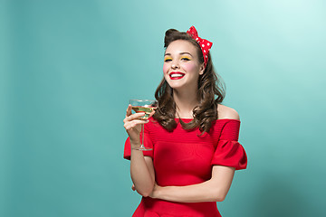 Image showing Beautiful young woman with pinup make-up and hairstyle. Studio shot on white background