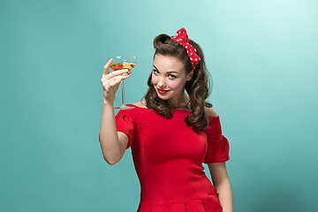 Image showing Beautiful young woman with pinup make-up and hairstyle. Studio shot on white background