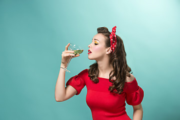 Image showing Beautiful young woman with pinup make-up and hairstyle. Studio shot on white background