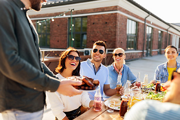 Image showing friends at barbecue party on rooftop in summer