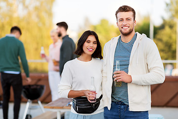 Image showing happy couple with drinks at rooftop party